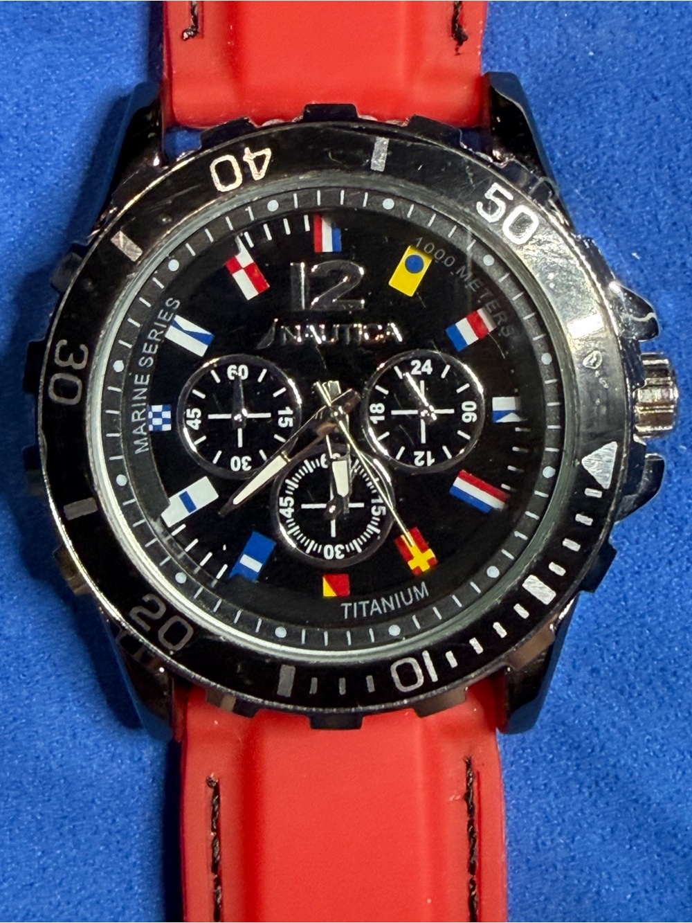 Nautica Black Dial Chronograph Watch with Red Strap and Nautical Flag Accents